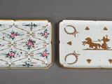 pair of small porcelain plates with a horse and rider on them