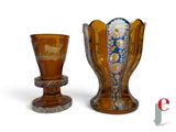 two vases sitting next to each other on a white surface