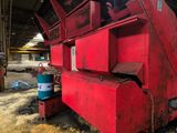a large red machine that is sitting in a building