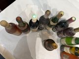 many bottles of wine sitting on a white table