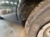 a close up of a tire on a car in a garage