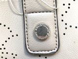 a white purse that has a coin in it