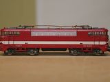 a red and white train on a table in a room