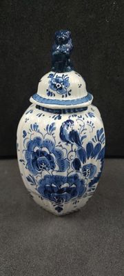 a blue and white vase with a bird on it