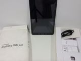 the samsung tablet is sitting on the table next to the box