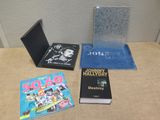 several books are sitting on a table next to a laptop