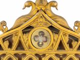 a gold clock with a picture of a man on it