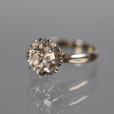 gros plan d'une bague en diamant sur une surface réfléchissante