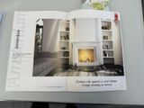 an open magazine with a picture of a fireplace in it