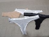 three pairs of underwear sitting on top of a bed next to each other