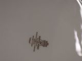 a white plate with a brown design on it