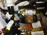 many bottles of wine sitting in a pile of clothes