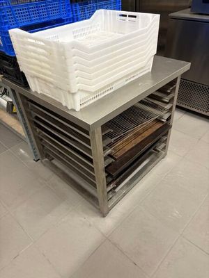 a stack of plastic containers sitting on a table in a kitchen