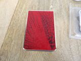 a cell phone sitting on a table next to a piece of paper