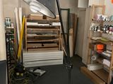 a desk with a computer and a lamp in a room