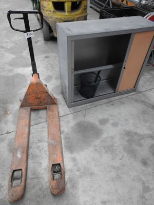 a fork lifter sitting next to a metal box