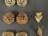 a close up of a bunch of gold jewelry on a table