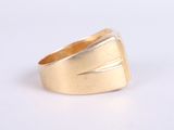 an image of a gold ring on a white surface
