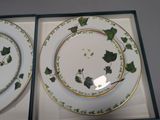 two plates with green leaves on them in a box