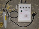 an electric device sitting on the floor next to a blue tub