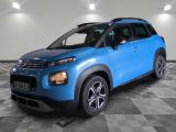 a blue citrole is parked in a room with a checkered floor