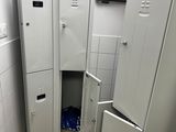 an image of a small bathroom with lockers in it
