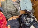 a pile of clothing and other items in a cardboard box