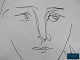 a drawing of a man ' s face on a piece of paper