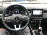 the steering wheel of a car with a person sitting in the drivers seat