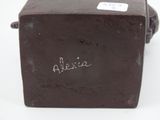 a brown box with writing on it sitting on a white surface