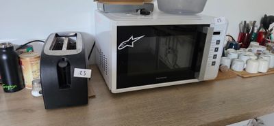 a microwave sitting on top of a counter next to a toaster oven