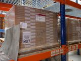 boxes are stacked on a pallet in a warehouse with a conveyor belt