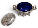 a blue bowl and a silver spoon sitting next to each other