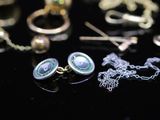 many different types of jewelry on a black surface
