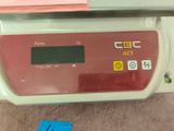 a scale with a clock on it on a table