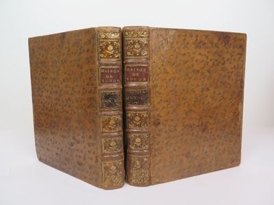 an old book with two pages in it sitting on a white surface