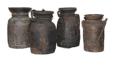 four vases sitting next to each other on a white surface