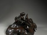 an image of a bronze statue of a man riding on a horse