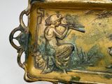a metal tray with a picture of a woman playing a flute