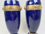 pair of blue vases with gold trim on each of them