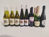 many bottles of wine that are lined up on the table