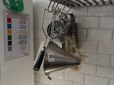a picture of a kitchen with a white refrigerator and a bunch of utensils hanging on the wall