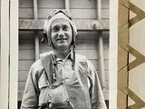 a black and white photo of a man in a helmet and overalls