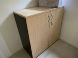 a box sitting on top of a cabinet in the corner of a room