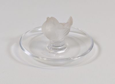 une plaque de verre sur laquelle est représentée une fleur, posée sur un fond blanc