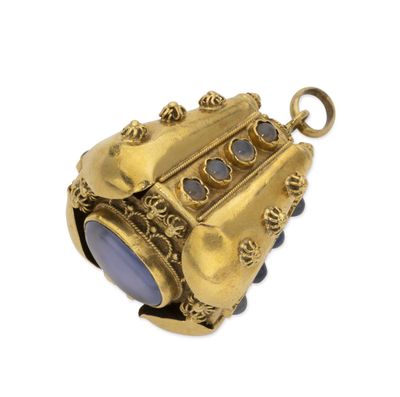 an antique gold locke with a blue stone in the center