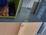 a green shelf with cleaning supplies on top of it