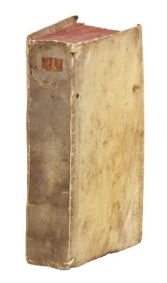 an old book that is sitting on a white surface