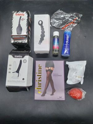 various items that are on a table including a bottle of wine, a pair of socks, a book, and a pair of scissors