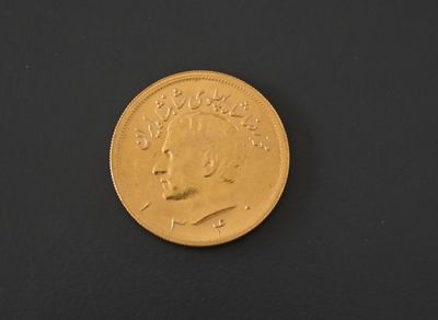 an image of a gold coin on a black surface